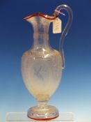 TWO BALUSTER GLASS JUGS, ONE WITH FACETTED CLEAR GLASS OVERLAYING RUBY. H 34.5 cms. THE OTHER WITH