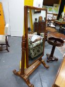 A VICTORIAN ASH CHEVAL MIRROR WITH TURNED UPRIGHTS AND ACORN FINIALS ON PLATFORM AND SCROLL BASE.