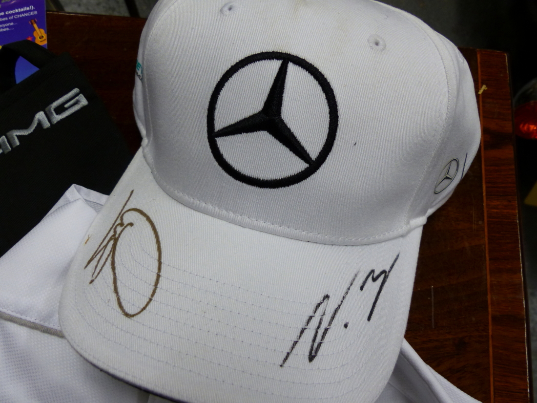 A COLLECTION OF PROGRAMMES AND CLOTHING SIGNED BY LEWIS HAMILTON, NELSON PIQUET, MARK WEBBER AND - Image 2 of 12