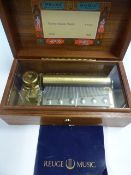 A REUGE MUSIC BOX PLAYING VIVALDI'S FOUR SEASONS ON A COMB. W 10.5cms. WITH 1991 GUARANTEE, THE