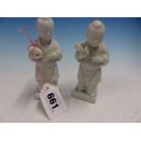 A PAIR OF BLANC DE CHINE FIGURES OF CHILDREN STANDING HOLDING FRUITS. H 12cms.