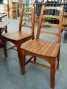 A SET OF FOUR UNUSUAL ARTS AND CRAFTS STYLE OAK LADDER BACK SIDE CHAIRS WITH DISHED SLAT SEATS. (4)