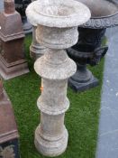A PAIR OF CARVED STONE PEDESTALS WITH URN FORM TOPS. H.82cms.