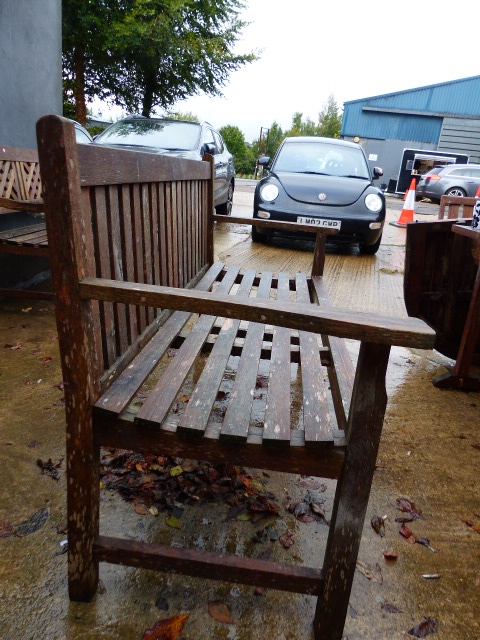 A TEAK GARDEN BENCH WITH PLAIN SLAT BACK. - Image 2 of 4