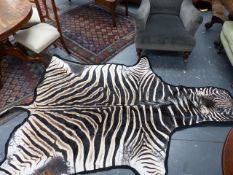 A BLUE CLOTH MOUNTED ZEBRA SKIN. W 280cms.