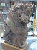 A FAR EASTERN CARVED HARDWOOD TEMPLE LION.