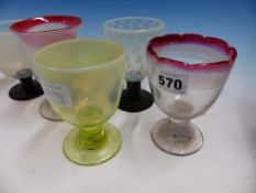 SIX COLOURED GLASS RUMMERS, THREE WITH RED RIMS, TWO WITH BLACK STEMS AND THE LAST OF VASELINE