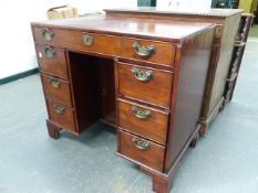 A GEO.III.MAHOGANY CADDY TOP KNEEHOLE DESK WITH CENTRAL CUPBOARD AND SEVEN DRAWERS ON BRACKET