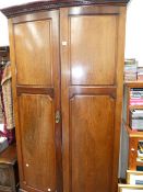 AN EDWARDIAN MAHOGANY BOW FRONT WARDROBE.