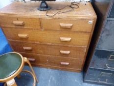 AN OAK CHEST OF DRAWERS.