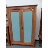 A SMALL PINE HALL CUPBOARD.