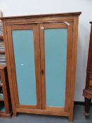 A SMALL PINE HALL CUPBOARD.