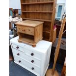 A PAINTED VICTORIAN CHEST OF DRAWERS, A TALL BOOKCASE AND A BEDSIDE CABINET.