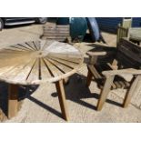 A CIRCULAR TEAK GARDEN TABLE AND A PAIR OF SIMILAR ARM CHAIRS.