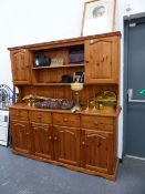 A PINE KITCHEN DRESSER AND RACK.