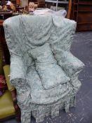 AN EDWARDIAN WING BACK ARMCHAIR.