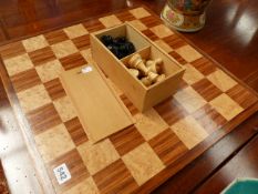 A CHESS BOARD AND PIECES.