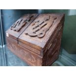 AN EASTERN HARDWOOD STATIONERY BOX WITH CARVED FRONT.