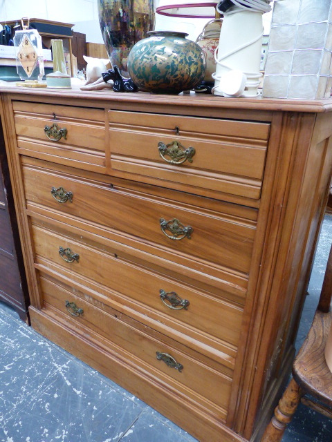 A SATINWOOD CHEST OF DRAWERS.
