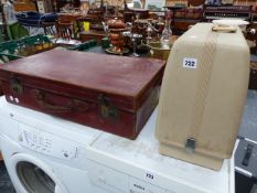 A LEATHER SUITCASE AND A SEWING MACHINE.