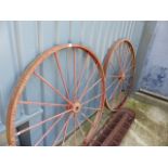 A PAIR OF CAST IRON WAGON WHEELS.