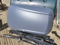 A ROOF BOX WITH ATTACHMENT BARS ETC.