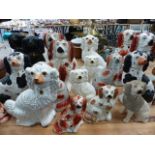 A LARGE COLLECTION OF VICTORIAN STAFFORDSHIRE SPANIELS.