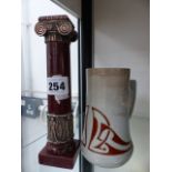 AN ORNATE HARDSTONE AND WHITE METAL MOUNTED CANDLE STICK.