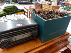 A BAKELITE RADIO AND BOX OF PINE CONES.