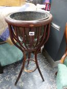 AN EDWARDIAN BENTWOOD JARDINIERE STAND.