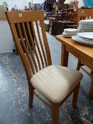 A SET OF EIGHT MODERN OAK DINING CHAIRS.