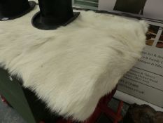 A SMALL HIDE RUG.