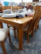 A LARGE OAK DINING TABLE.