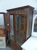 AN OAK GLAZED DISPLAY CABINET.