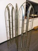 A WROUGHT IRON AND MIRORRED FOLDING SCREEN WITH TEA LIGHT HOLDERS.