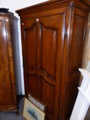 A CONTINENTAL STYLE PANEL DOOR ARMOIRE.