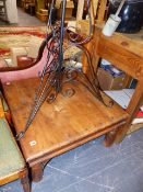 AN EASTERN COFFEE TABLE AND A WROUGHT IRON JARDINIERE STAND.