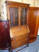 AN OAK BUREAU BOOKCASE.