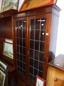 A GLAZED BOOKCASE AND A TALLBOY CABINET.