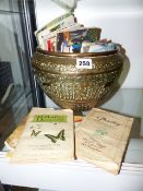 A LARGE EASTERN BRASS BOWL AND A COLLECTION OF CIGARETTE AND TEA CARDS.