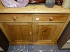 A SMALL PINE SIDE CABINET.