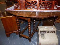 AN OAK GATELEG TABLE WITH BOBBIN SUPPORTS.