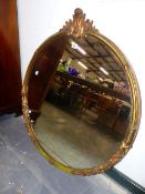 A LARGE CIRCULAR WALL MIRROR.