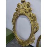 AN ELABORATE GILT MIRROR FRAME.