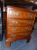 A PAIR OF MINIATURE BOW FRONT FOUR DRAWER CHESTS.