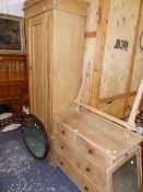 AN EDWARDIAN PINE WARDROBE AND A MIRROR BACK DRESSING CHEST.