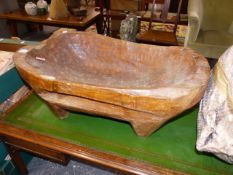 A WOODEN DUG OUT BOWL AND A PLASTER PLANTER.