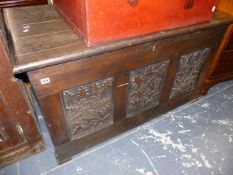 AN ANTIQUE OAK PANEL FRONT COFFER.