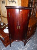 A GEORGIAN MAHOGANY BOW FRONT CORNER CABINET ON STAND.
