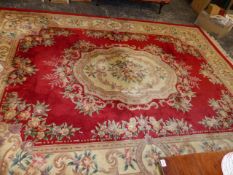 A LARGE CHINESE RED GROUND RUG.